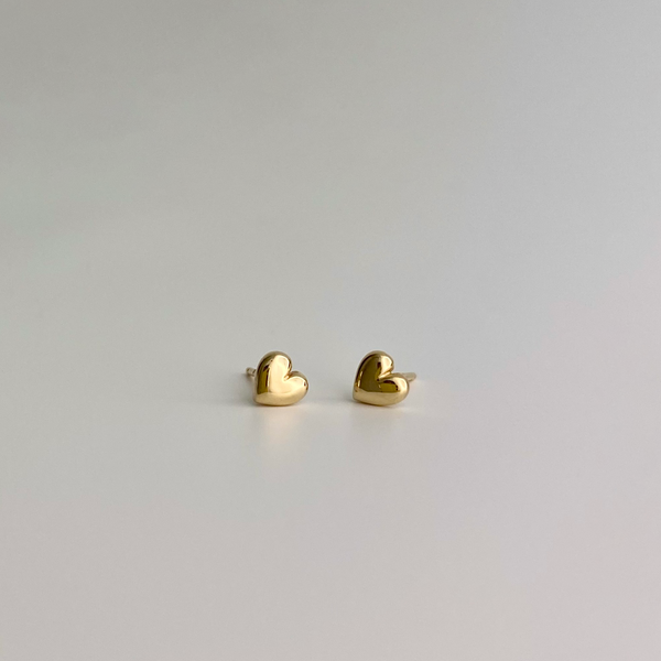 two dainty gold stud heart earrings